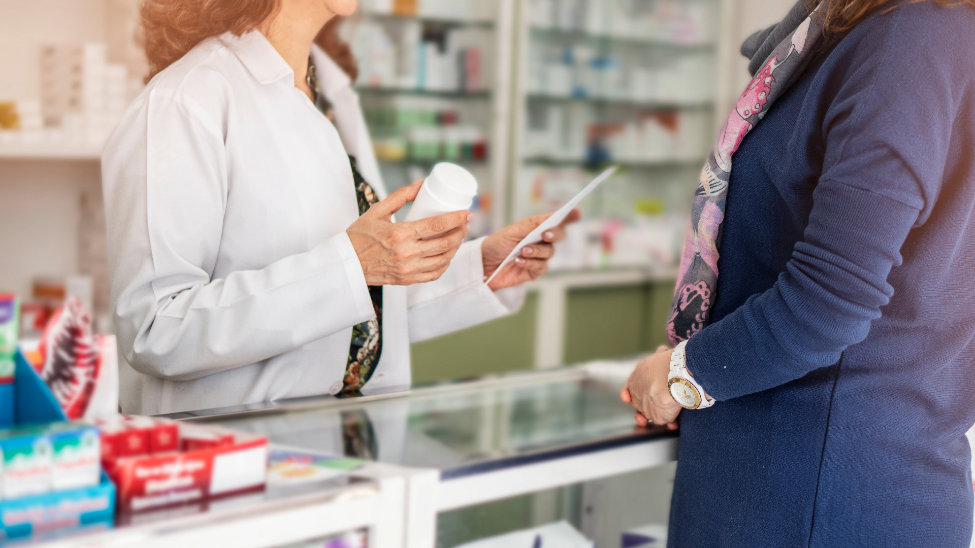 A pharmacist consults with a patient about medication.