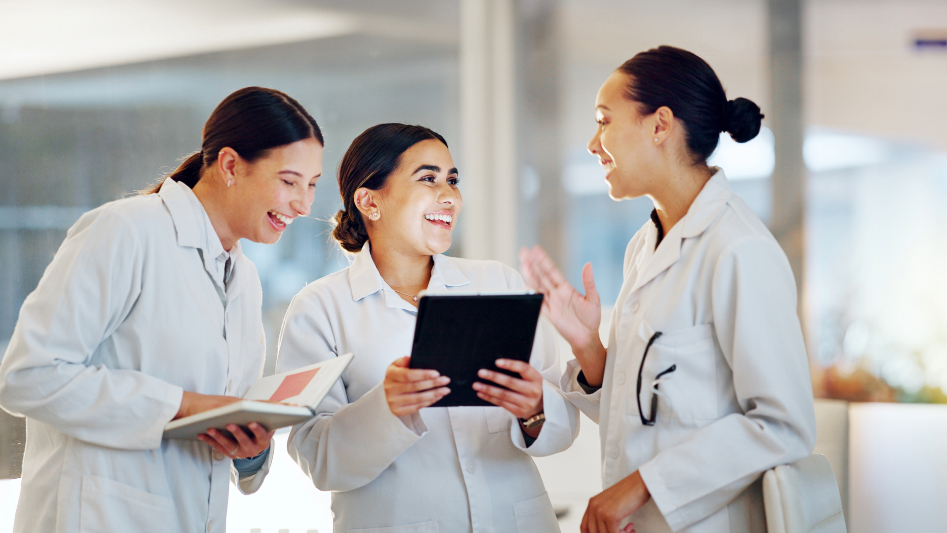 Student pharmacists gather around a tablet. 