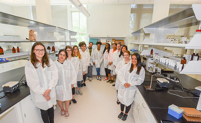 Whitecoat students posing for photo in a lab.