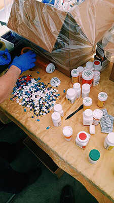Pills displayed on table.