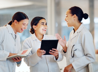 Student pharmacists gather around a tablet. 