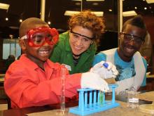 An OSU student pharmacist helps museum visitors with an experiment at the Generation Rx Lab.