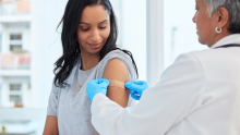 Pharmacist attends to a patient after a successful vaccination.