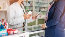A pharmacist consults with a patient about medication.